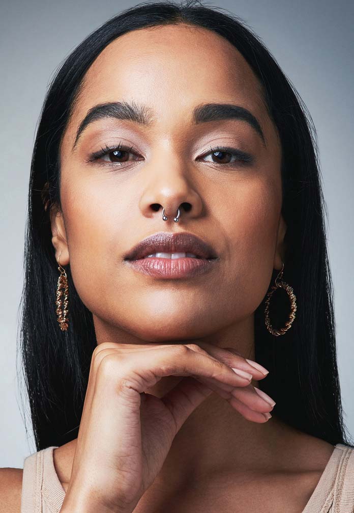 Shot of a beautiful young woman posing against a grey background Truesdale Facial Plastic Surgery
